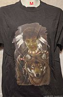 Front view of black T-shirt with Native woman and wolf graphic