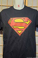 Front view showing Superman logo graphic on black T-shirt