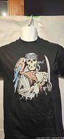 Front view of black T-shirt with pirate skeleton graphic displayed on torso mannequin