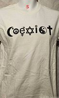 Front view of off-white men's small T-shirt displaying black "Coexist" symbol graphic