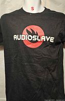 Front view showing Audioslave logo and overall condition