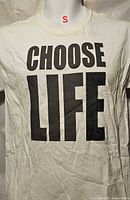 Front view of white T-shirt displaying large black 'CHOOSE LIFE' text