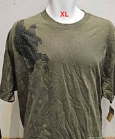 Front view of olive green Vans T-shirt with eagle graphic on mannequin