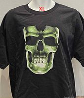 Front of black T-shirt with green skull graphic displayed on mannequin, size XL noted