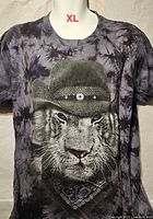 Front view of T-shirt showing tie-dye pattern and cat with cowboy hat graphic
