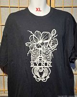 Front view of black T-shirt with skeleton and flower graphic