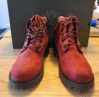 Front view of both red Timberland boots showing laces, toe shape and soles