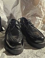 Front view showing both shoes, woven vamp, platform sole