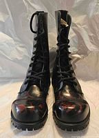 Front view of both boots showing lace system, toe caps, tread