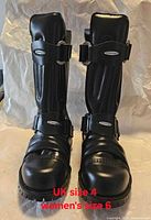 Front view of both boots showing straps, toe, branding and condition