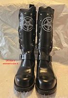 Front view showing both boots, pentagram emblems, toe caps