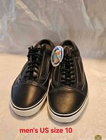 Front view of both sneakers showing leather uppers, laces, stitching, size annotation