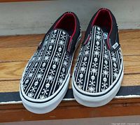 Top view of Vans slip-on shoes showing pattern and condition