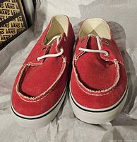 Front view of red canvas Vans boat shoes