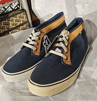 Front angle of both navy and tan Vans sneakers with tags attached