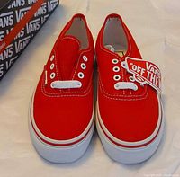 Top view of both red Vans shoes showing uppers and tag