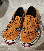Top view of both shoes showing fish-scale design and printed eyes