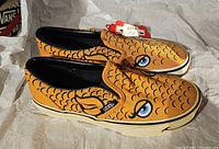 Left side view of both goldfish design Vans shoes