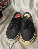 Top view of both shoes showing uppers, laces, size tag inside, and rubber foxing