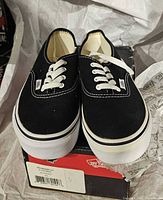 Black Vans Authentic shoes on box, laces tied