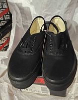 Top view of pair showing laces, eyelets and tag