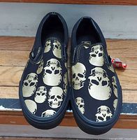 Top view of both shoes showing skull print and hang tag
