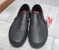 Top view of both shoes showing Black Widow logos and hang tag