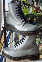 Side view of both silver Dr. Martens boots on display