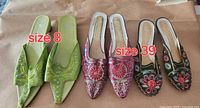 Three pairs green, magenta and black beaded mules with size labels 8 and 39 visible