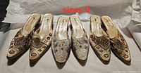 Four pointed-toe mules showing embroidery and sequin detail, size 9 label visible