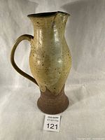 Full view of pitcher front showing glaze and handle