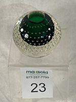 Full view of spherical green-core bullicante glass candle holder