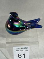Side profile of iridescent cobalt bird paperweight