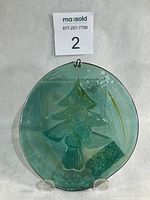 Full view of circular emerald glass suncatcher on stand