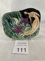 Front view of glazed earthenware soap dish with goddess, stars and moon motif