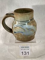 Left-side view of mug showing handle, glaze, thumb rest