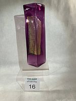 Full side view of purple vase on clear stand showing gold leaf inclusion