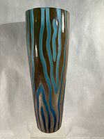 Full front view of tall iridescent brown and turquoise etched glass vase