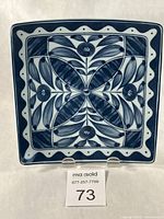 Front view of square blue and white porcelain plate on stand