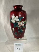 Front view showing full vase, floral design and red ginbari background