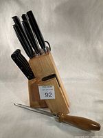 Knife block with knives inserted and honing steel laid beside