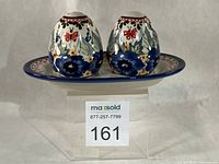 Front view of two shakers on tray showing pattern and form
