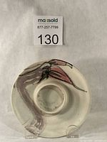 Front view of porcelain candle holder with floral brush design