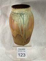 Front view of stoneware vase showing glaze drips and overall shape