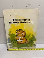 Front of oversized Garfield card with ruler for scale