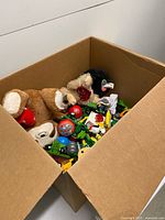 Top view of box showing plush animals and mixed toys
