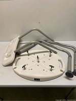 Disassembled Carex shower chair parts on table