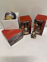 Group shot of all four ornaments and their boxes