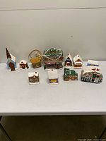 Full set of ceramic Christmas village buildings on table