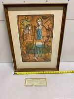 Full view of framed etching with certificate and tape measure showing scale